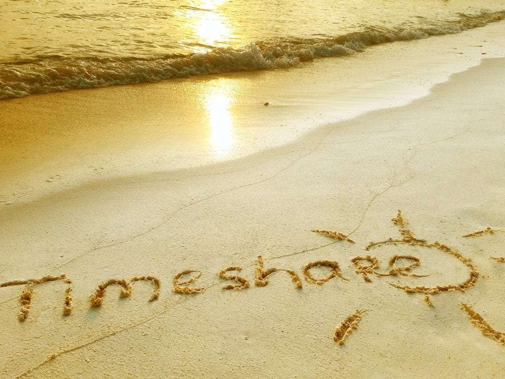 Timeshare written in the sand on a beach
