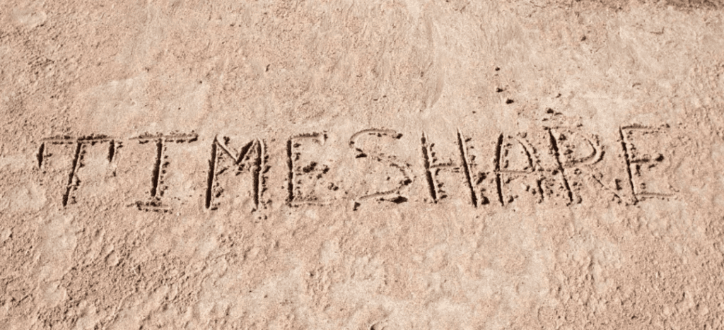 a beach with timeshare written in the sand