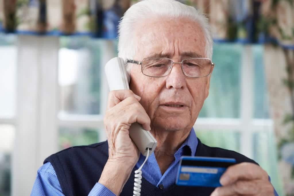 Older man being scammed by timeshare cold callers