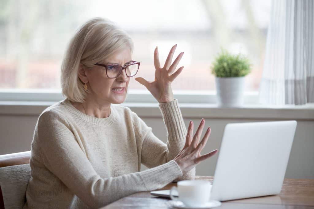 Woman frustrated at laptop due to Azure Timeshare Scam