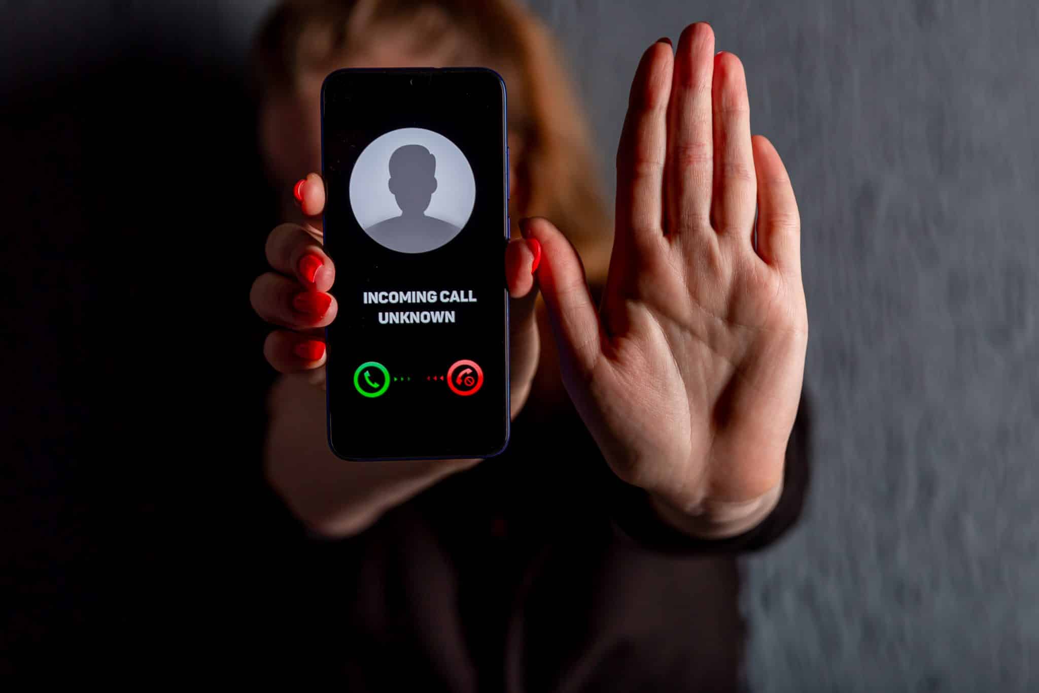 Phone call from unknown number. Scam, fraud or phishing with smartphone concept. Prank caller, scammer or stranger. Woman answering to incoming call. Timeshare exit scammer with fake identity