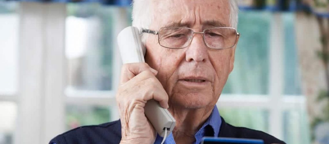 Older man being scammed by timeshare cold callers