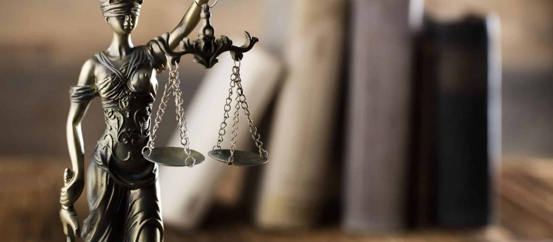 Scales of justice with law books